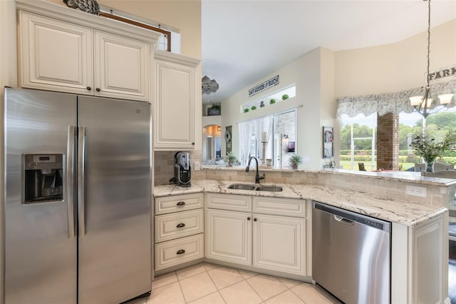 441 Hightower Dr, Debary, FL 32713 - kitchen with stainless steel appliances, a sink, a chandelier, light stone countertops, and light tile patterned floors