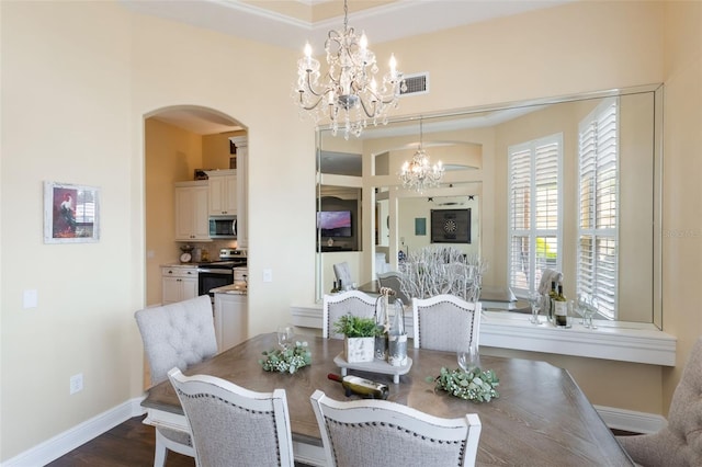 441 Hightower Dr, Debary, FL 32713 - dining space featuring a chandelier, arched walkways, baseboards, and dark wood finished floors
