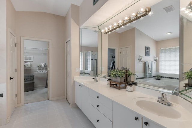 441 Hightower Dr, Debary, FL 32713 - bathroom featuring tile patterned floors, a spacious closet, double vanity, and a bath