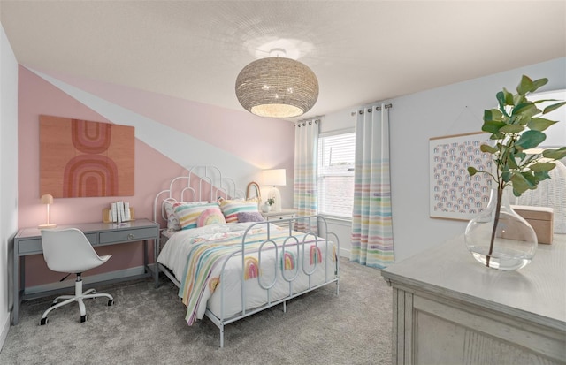 bedroom with carpet floors, lofted ceiling, and baseboards
