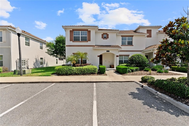 1596 Moon Valley Dr, Davenport, FL 33896 - view of front facade featuring uncovered parking, stucco siding, and a tiled roof