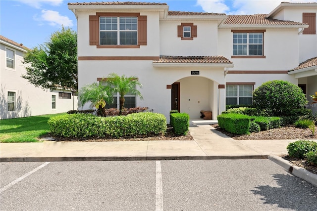 1596 Moon Valley Dr, Davenport, FL 33896 - townhome / multi-family property with a tile roof, uncovered parking, and stucco siding