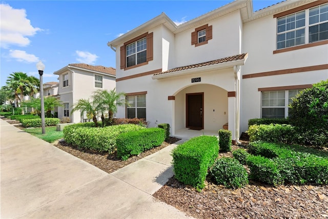 1596 Moon Valley Dr, Davenport, FL 33896 - view of property with stucco siding and a tiled roof