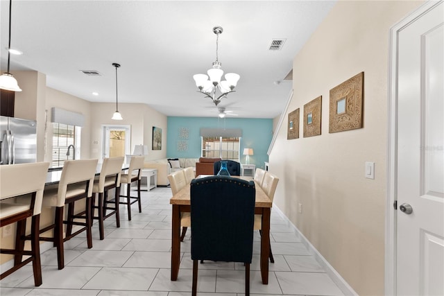1596 Moon Valley Dr, Davenport, FL 33896 - dining area featuring a chandelier and baseboards
