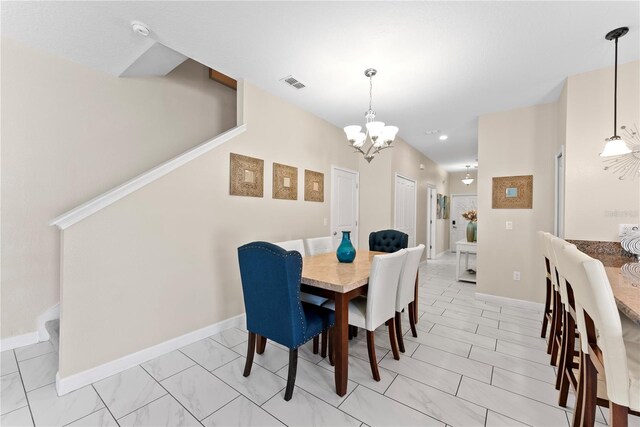 1596 Moon Valley Dr, Davenport, FL 33896 - dining area with a chandelier, baseboards, and light marble finish flooring