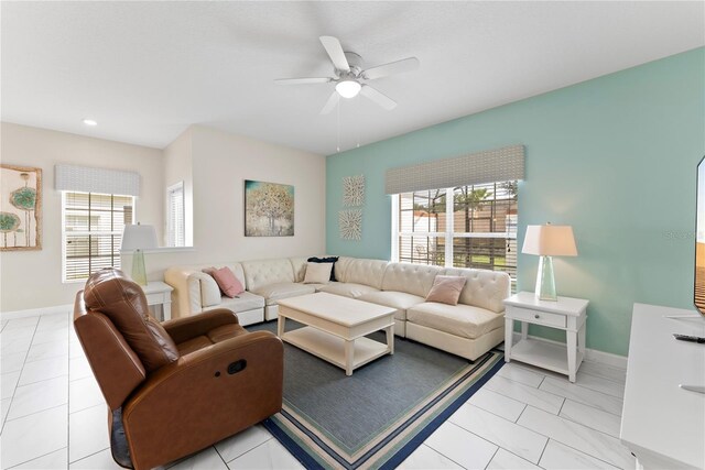 1596 Moon Valley Dr, Davenport, FL 33896 - living room with plenty of natural light, ceiling fan, baseboards, light tile patterned flooring, and recessed lighting