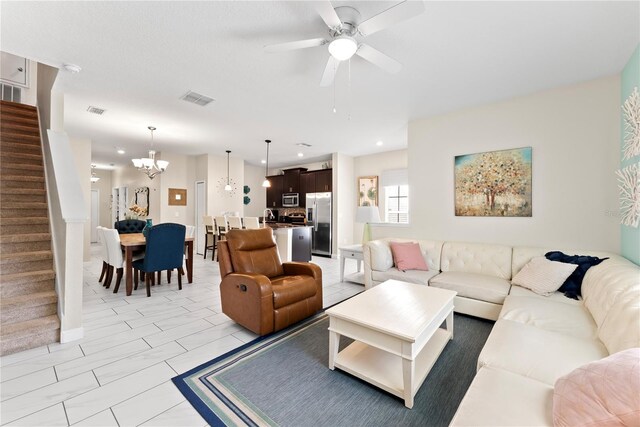 1596 Moon Valley Dr, Davenport, FL 33896 - living room featuring stairs, ceiling fan, a chandelier, and recessed lighting