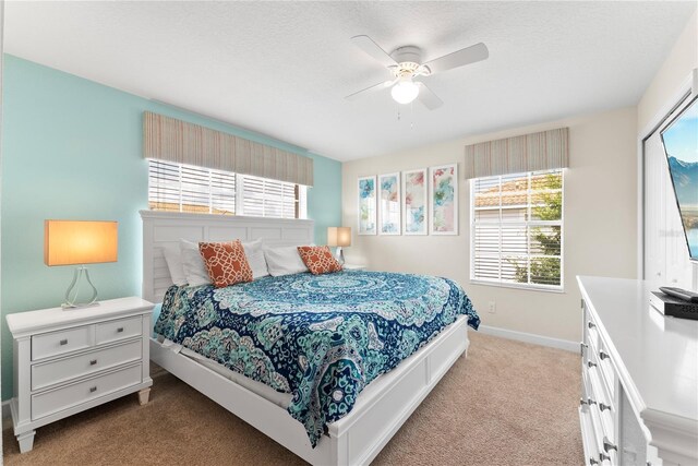 1596 Moon Valley Dr, Davenport, FL 33896 - carpeted bedroom featuring multiple windows, baseboards, and a ceiling fan