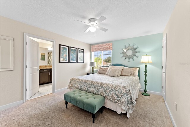 1596 Moon Valley Dr, Davenport, FL 33896 - bedroom featuring light carpet, a textured ceiling, connected bathroom, a ceiling fan, and baseboards
