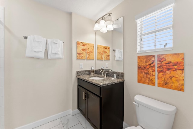 1596 Moon Valley Dr, Davenport, FL 33896 - bathroom with toilet, marble look tile flooring, baseboards, and vanity