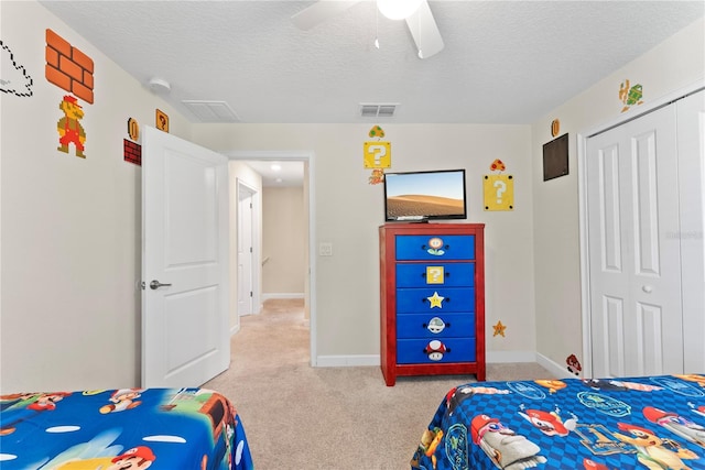 1596 Moon Valley Dr, Davenport, FL 33896 - bedroom with a closet, light carpet, a textured ceiling, a ceiling fan, and baseboards