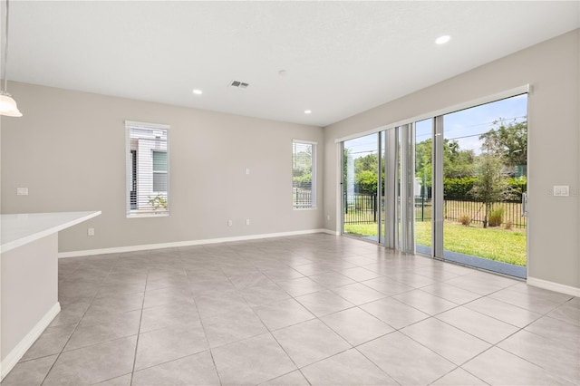 1915 Terrapin Rd, Ocoee, FL 34761 - empty room featuring healthy amount of natural light, baseboards, light tile patterned floors, and recessed lighting
