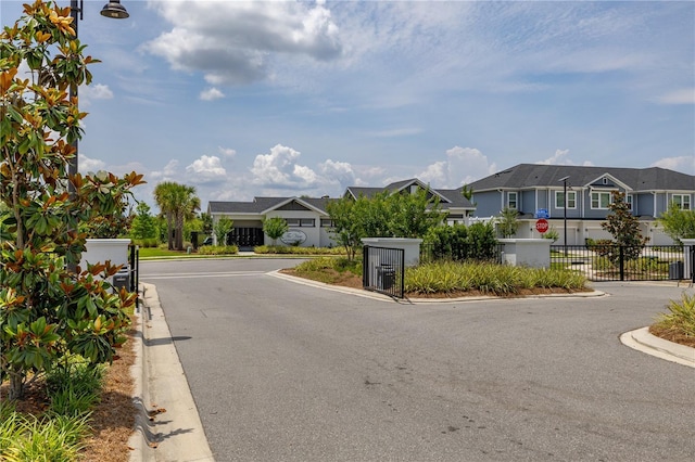 1915 Terrapin Rd, Ocoee, FL 34761 - view of asphalt street with a residential view, traffic signs, curbs, street lighting, and a gated entry