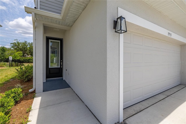 1915 Terrapin Rd, Ocoee, FL 34761 - property entrance with a garage, fence, and stucco siding