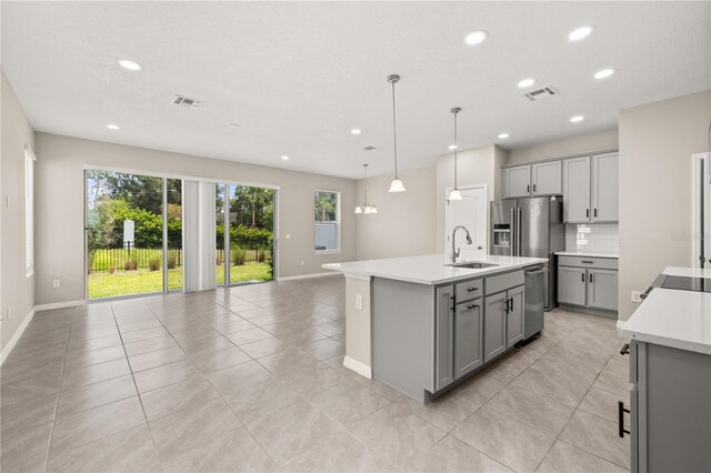 1915 Terrapin Rd, Ocoee, FL 34761 - kitchen with gray cabinetry, stainless steel appliances, a sink, light countertops, and recessed lighting