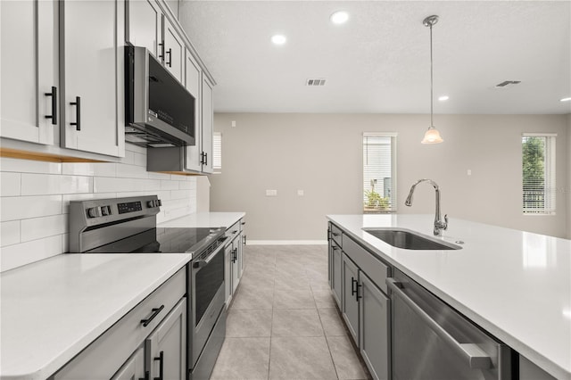 1915 Terrapin Rd, Ocoee, FL 34761 - kitchen featuring appliances with stainless steel finishes, a sink, backsplash, light countertops, and recessed lighting