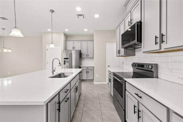 1915 Terrapin Rd, Ocoee, FL 34761 - kitchen with appliances with stainless steel finishes, a sink, gray cabinets, decorative backsplash, and recessed lighting