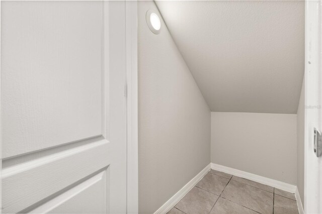 1915 Terrapin Rd, Ocoee, FL 34761 - bonus room with lofted ceiling, light tile patterned floors, and baseboards