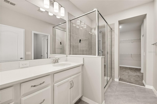 1915 Terrapin Rd, Ocoee, FL 34761 - full bath with a stall shower, tile patterned floors, vanity, baseboards, and a spacious closet