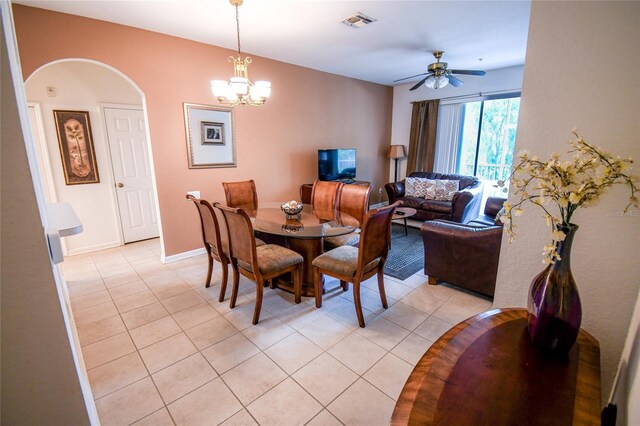 2788 Almaton Loop Unit 202, Kissimmee, FL 34747 - dining space with light tile patterned floors, a ceiling fan, a chandelier, and arched walkways