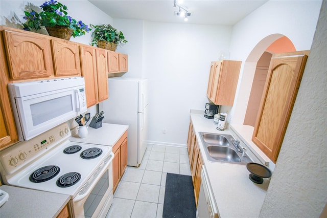 2788 Almaton Loop Unit 202, Kissimmee, FL 34747 - kitchen featuring white appliances, light countertops, arched walkways, light tile patterned floors, and a sink