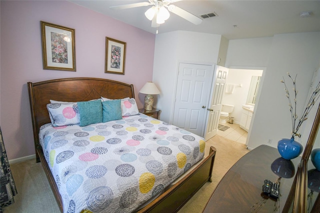 2788 Almaton Loop Unit 202, Kissimmee, FL 34747 - bedroom with light colored carpet, connected bathroom, baseboards, and ceiling fan