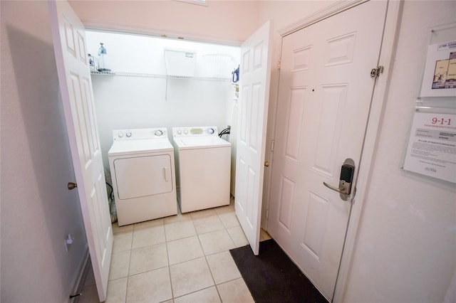 2788 Almaton Loop Unit 202, Kissimmee, FL 34747 - laundry room with washing machine and dryer and light tile patterned flooring