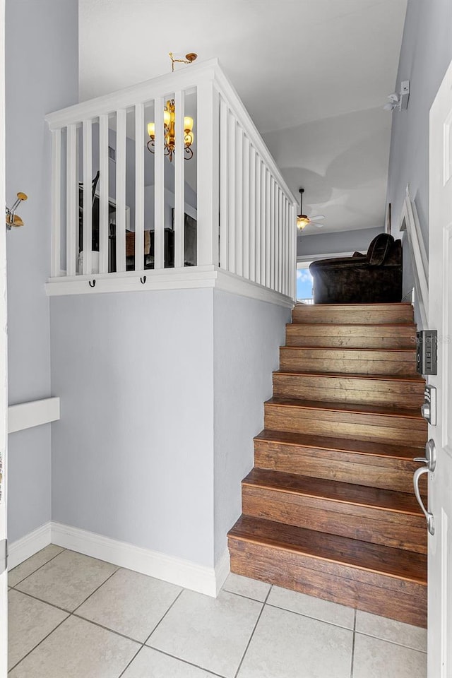 425 Eagle Ridge Dr Unit 425, Davenport, FL 33837 - stairs featuring tile patterned flooring, a ceiling fan, a chandelier, and baseboards