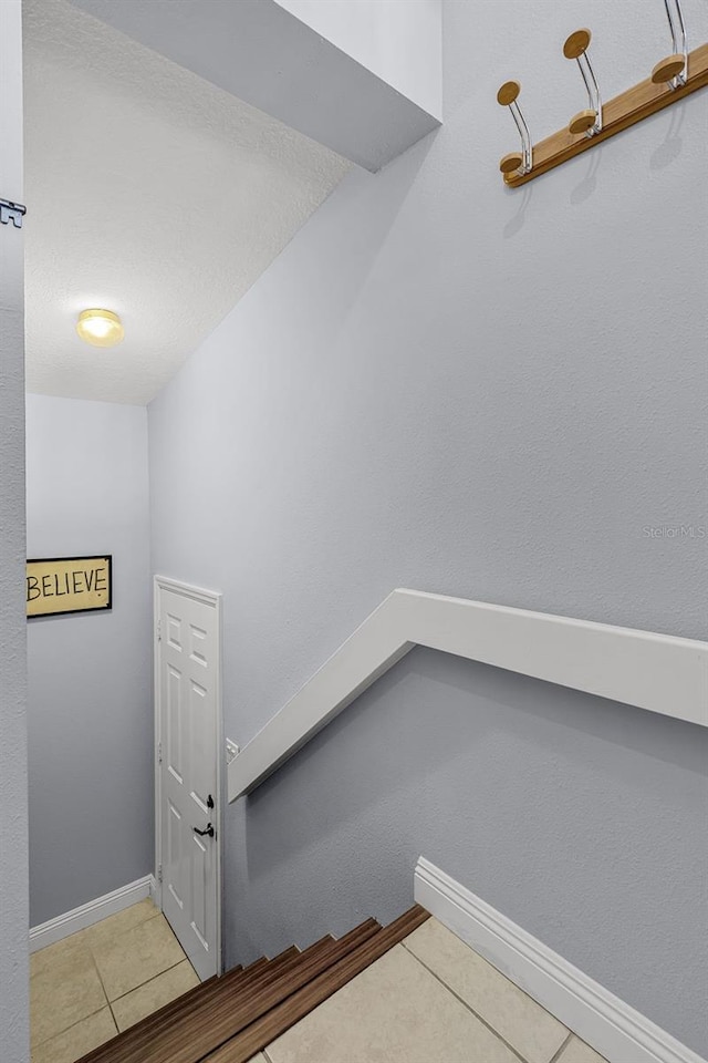 425 Eagle Ridge Dr Unit 425, Davenport, FL 33837 - staircase featuring tile patterned flooring and baseboards