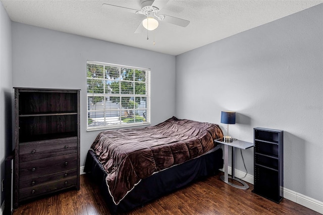425 Eagle Ridge Dr Unit 425, Davenport, FL 33837 - bedroom featuring wood finished floors, baseboards, ceiling fan, and a textured ceiling