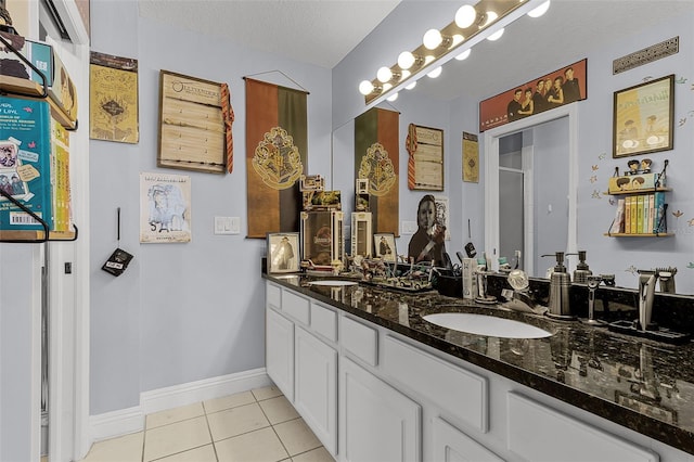 425 Eagle Ridge Dr Unit 425, Davenport, FL 33837 - full bath featuring tile patterned flooring, baseboards, double vanity, a stall shower, and a textured ceiling