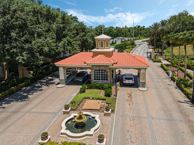 425 Eagle Ridge Dr Unit 425, Davenport, FL 33837 - mediterranean / spanish house with stucco siding, driveway, a tile roof, and stone siding