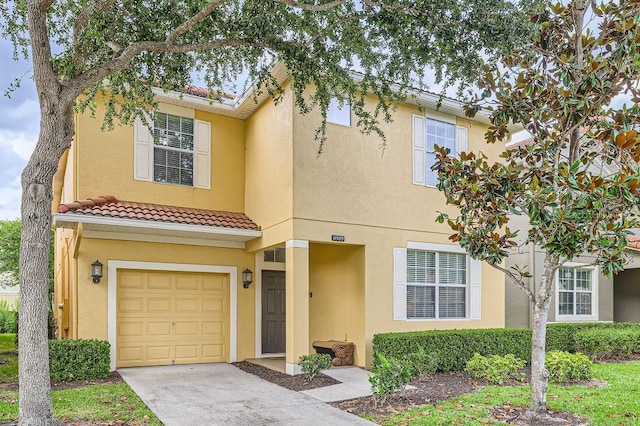 multi unit property featuring a garage, a tiled roof, stucco siding, and concrete driveway