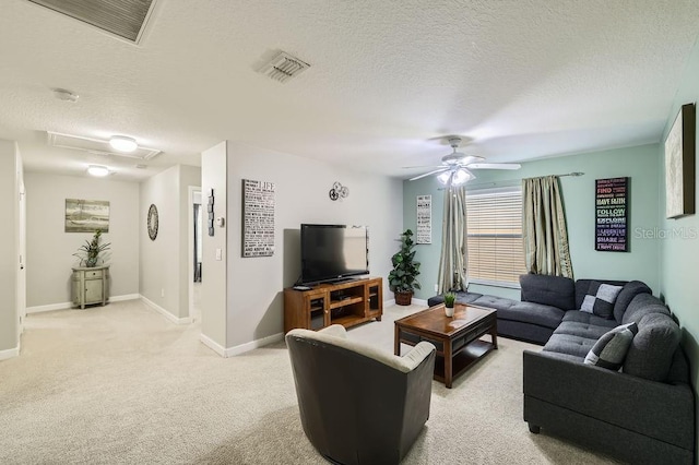 living area featuring a textured ceiling, ceiling fan, light carpet, and baseboards