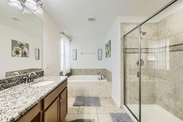 bathroom with a shower stall, a bath, tile patterned floors, and vanity