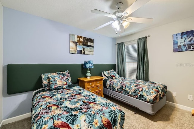 carpeted bedroom with baseboards and a ceiling fan