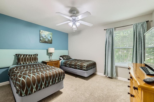 bedroom featuring carpet flooring, baseboards, and a ceiling fan