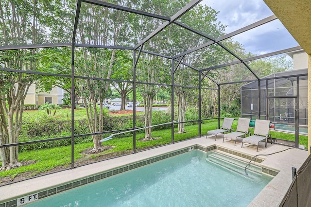 outdoor pool featuring a patio, a lanai, and a yard