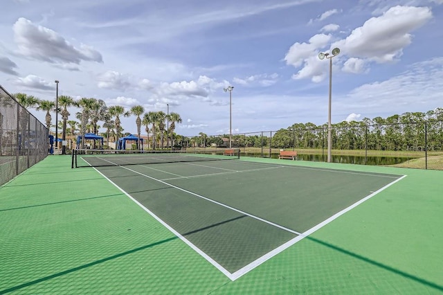 view of tennis court featuring fence