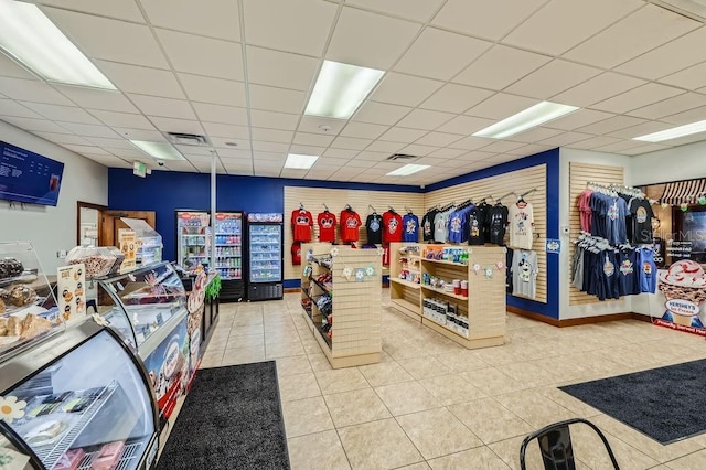 misc room featuring a drop ceiling and tile patterned floors