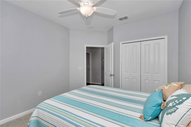 carpeted bedroom featuring a closet, baseboards, and ceiling fan