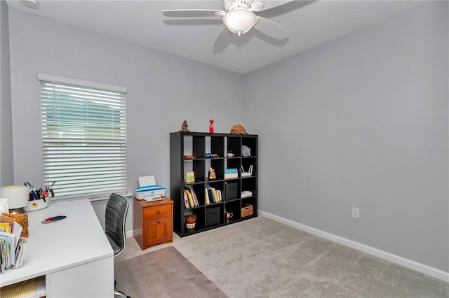 office with ceiling fan, light carpet, and baseboards