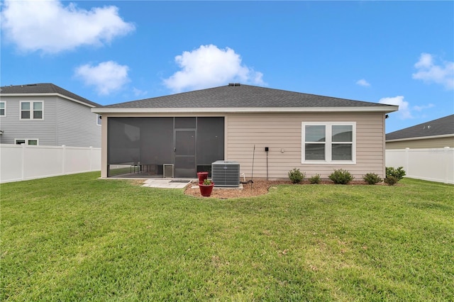 rear view of property featuring a sunroom and central AC