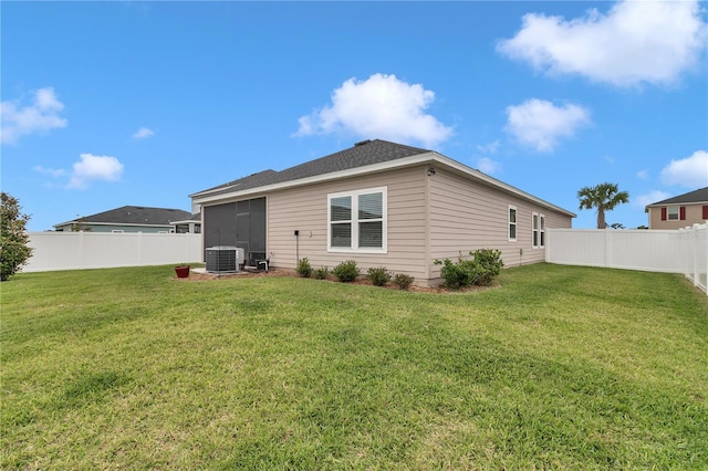 rear view of property featuring a sunroom and cooling unit