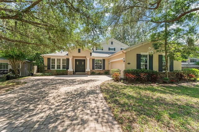 2827 Park Meadow Dr, Apopka, FL 32703 - traditional-style home featuring an attached garage, stucco siding, driveway, and stone siding