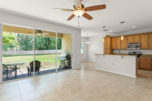 2827 Park Meadow Dr, Apopka, FL 32703 - kitchen with stainless steel appliances, brown cabinets, stone countertops, a breakfast bar area, and a ceiling fan