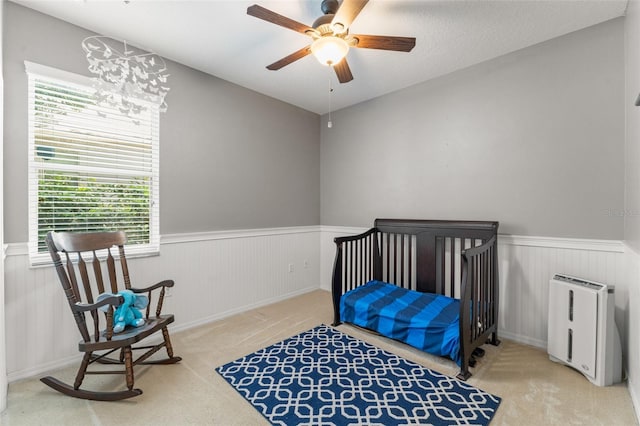 2827 Park Meadow Dr, Apopka, FL 32703 - bedroom featuring a wainscoted wall, carpet, multiple windows, and ceiling fan