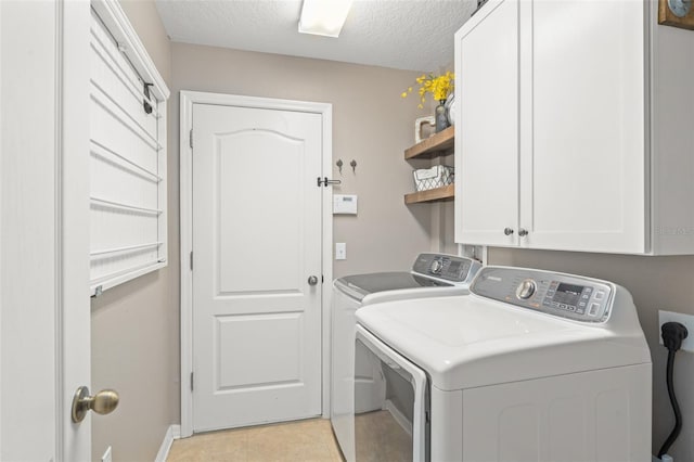 2827 Park Meadow Dr, Apopka, FL 32703 - washroom with washer and dryer, cabinet space, a textured ceiling, and light tile patterned flooring
