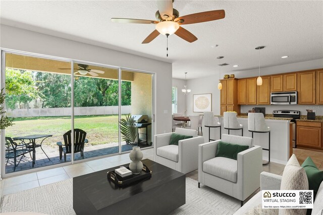 2827 Park Meadow Dr, Apopka, FL 32703 - living room featuring ceiling fan, recessed lighting, light tile patterned floors, and a textured ceiling