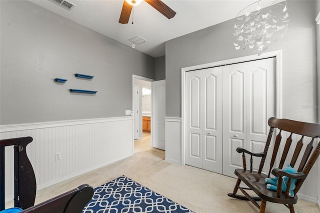 2827 Park Meadow Dr, Apopka, FL 32703 - sitting room with wainscoting, ceiling fan, and light carpet